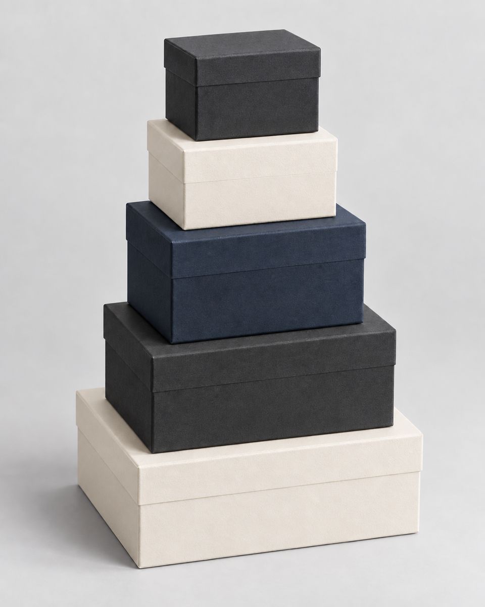 Stack of five custom packaging boxes in ascending sizes, showing the range of box dimensions available.